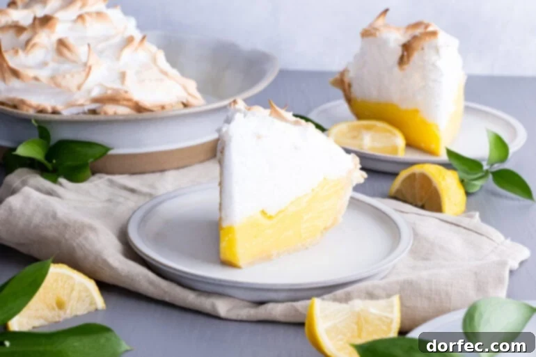 Family Recipe Lemon Meringue Pie 2 a photo of a piece of lemon meringue pie sitting on a small white dessert plate