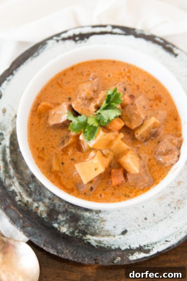Classic Slow Cooker Beef Stew for Family Dinners Hearty beef stew simmering in a slow cooker, packed with tender meat and vegetables.