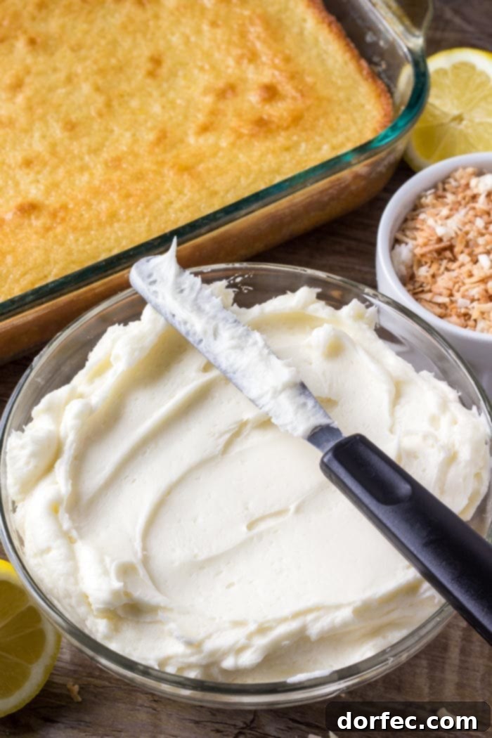Close-up of creamy, fluffy coconut buttercream frosting, the perfect complement to a moist lemon cake.