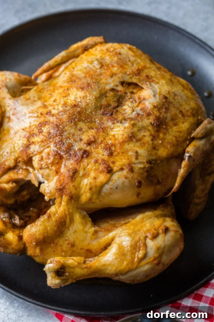 Ultimate Instant Pot BBQ Whole Chicken 3 A red and white checkered napkin under a grey plate with a bbq instant pot whole chicken on top!