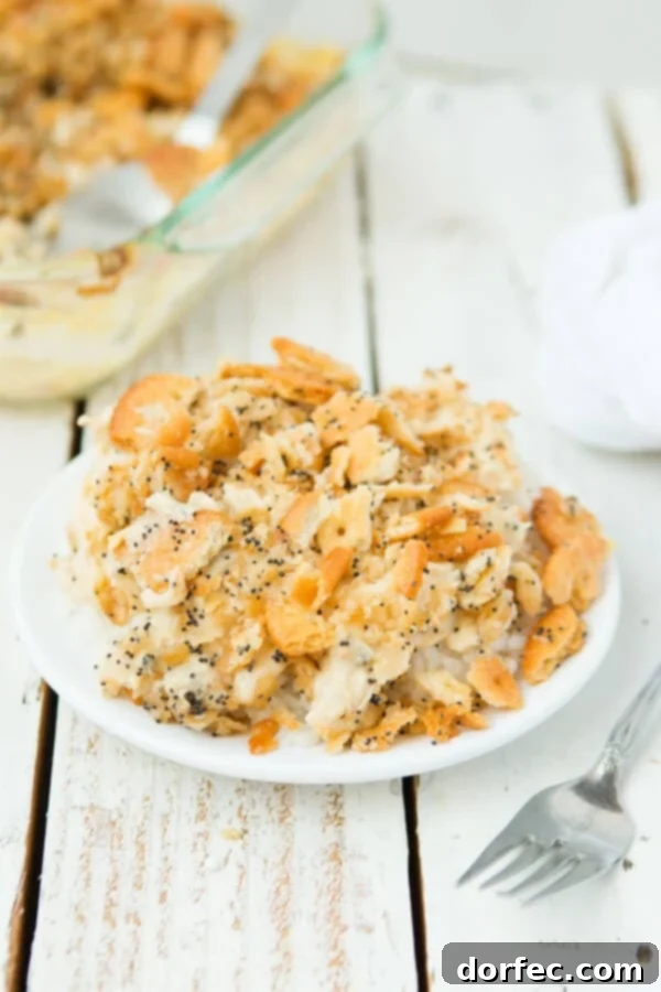 Deliciously creamy Poppy Seed Chicken Casserole with a irresistible Ritz cracker crust. Close-up of creamy Poppy Seed Chicken Casserole with golden Ritz crackers on top, served on a white plate.