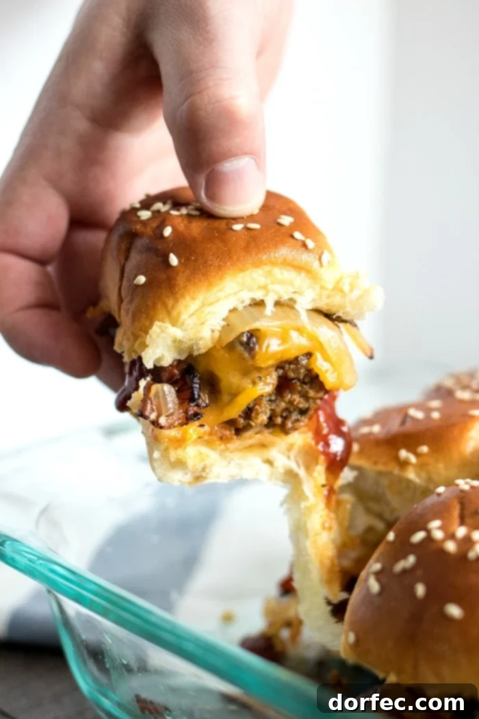 pulling a bbq meatball slider from baking tray
