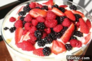 Tangy Berry Bliss Trifle 2 A beautifully assembled Lemon Curd Berry Trifle, topped with fresh mint leaves, ready to be served at a festive gathering.