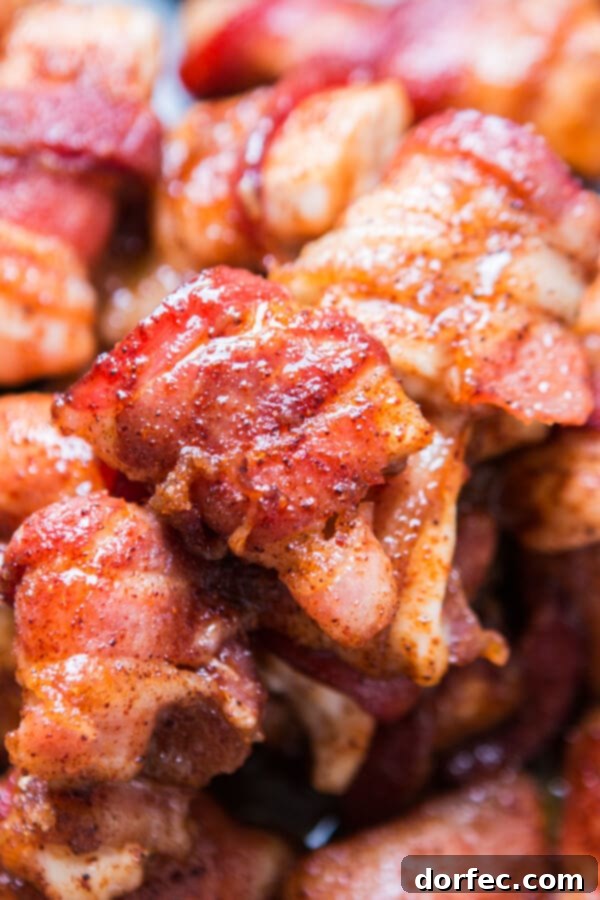 Close-Up of Glazed Bacon-Wrapped Chicken Bites close up of baked bacon wrapped chicken pieces, glistening with a sweet glaze