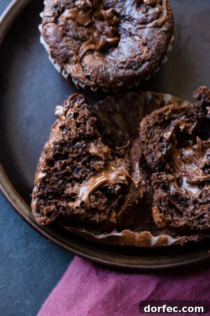A close-up of a Nutella stuffed chocolate banana muffin, showcasing its moist texture