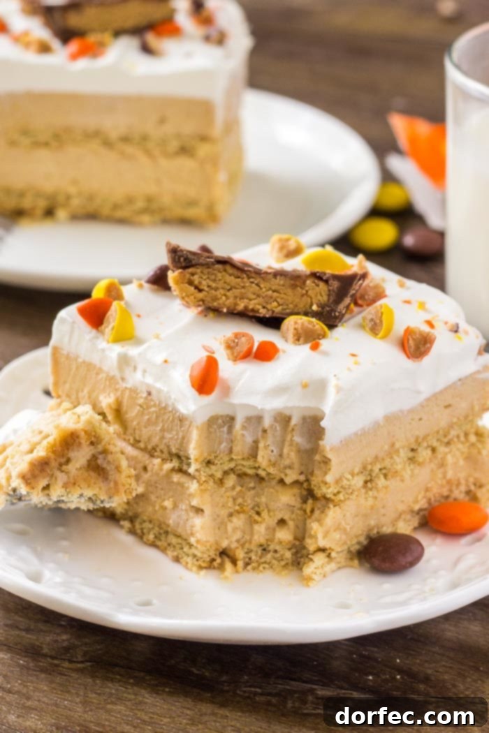 A slice of creamy peanut butter icebox cake with whipped topping and peanut butter cups.