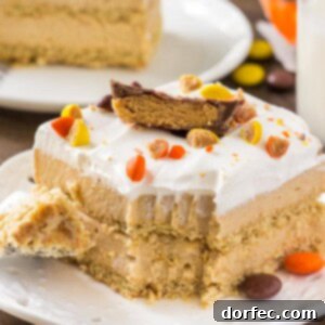A slice of creamy peanut butter icebox cake with whipped topping and peanut butter cups.