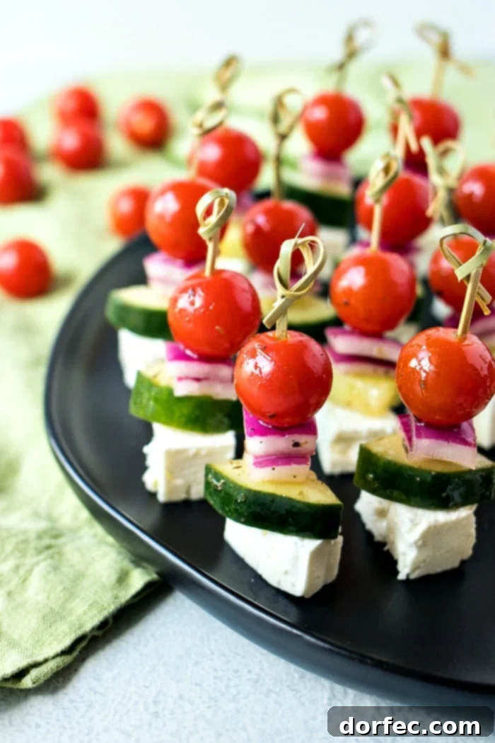 Fresh Greek Salad Skewers 2 Greek Salad Skewers featuring cherry tomatoes, cucumber, red onion, and feta cheese, tossed in a homemade Greek vinaigrette