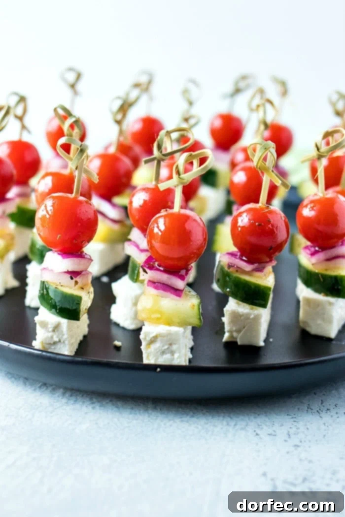 Fresh Greek Salad Skewers 3 Greek Salad Skewers prepared with fresh cherry tomatoes, cucumber, red onion, and crumbled feta cheese, dressed in a light vinaigrette