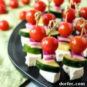 Fresh Greek Salad Skewers 10 Greek Salad Skewers - Cherry tomatoes, cucumber, and red onion are tossed in a homemade Greek vinaigrette and layered on mini skewers with a little square of feta cheese.
