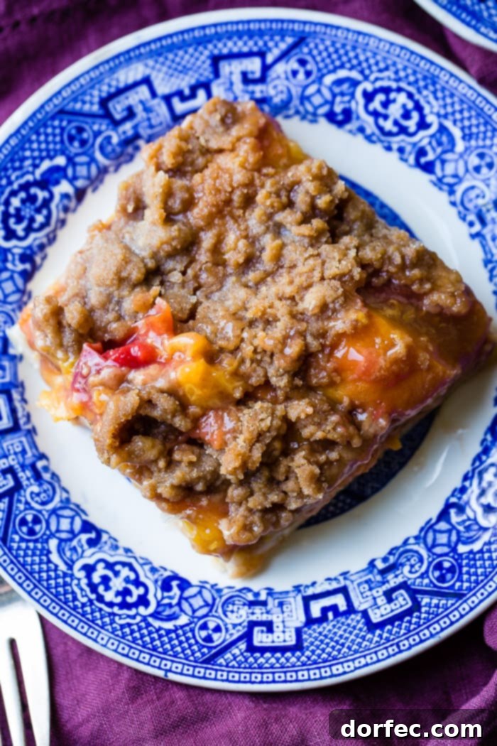 Delicious slice of Brown Sugar Peach Pie Bars on a blue plate