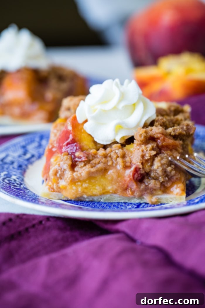 Close-up of a Brown Sugar Peach Pie Bar slice, ready to be enjoyed