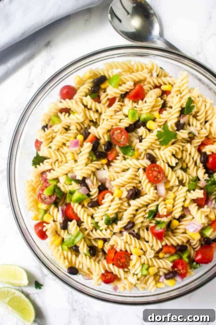 Zesty Tex-Mex Pasta Salad 3 A large, inviting bowl of Mexican pasta salad, vibrant with vegetables and tossed in a bright chili lime vinaigrette.