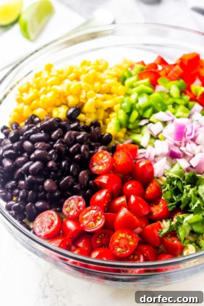 Zesty Tex-Mex Pasta Salad 4 A colorful array of chopped tomatoes, black beans, corn, bell peppers, red onion, and fresh cilantro, ready to be transformed into a delicious Southwest pasta salad.