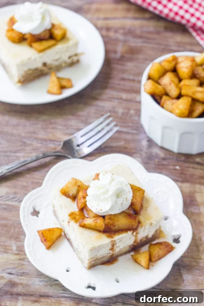 Caramel Apple Cheesecake Bars 4 A slice of apple cheesecake bars topped with cinnamon sugar apples and whipped cream