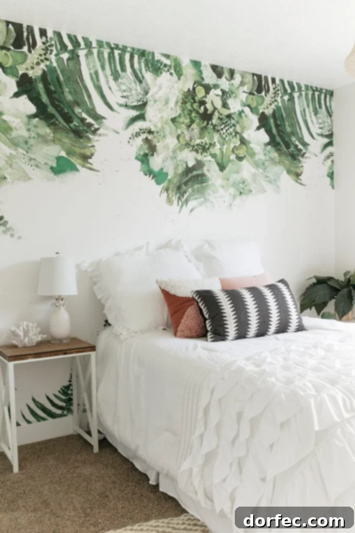 Modern palm leaf removable wallpaper in a beach themed tween bedroom with white bedding