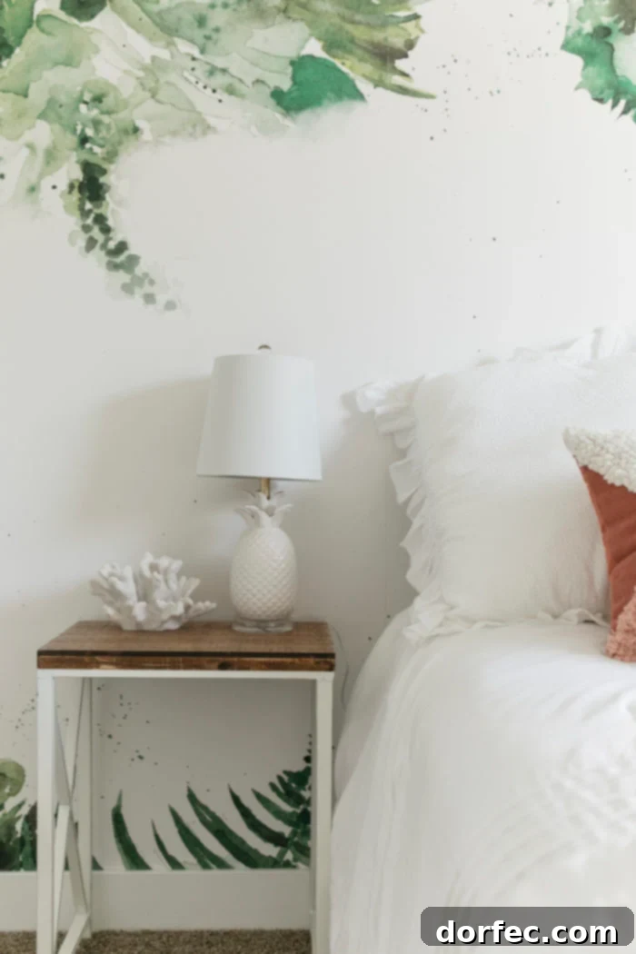 Full view of serene beach themed tween bedroom with palm leaf wall art and cozy bedding