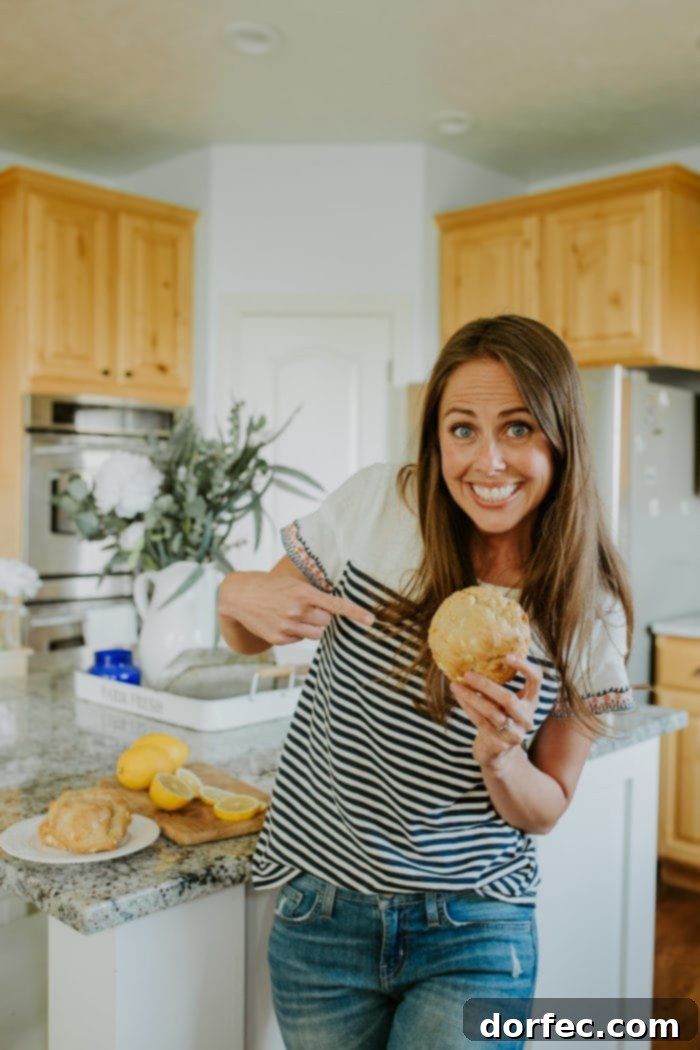 carrian from ohsweetbasil.com pointing at a lemon cookie from goodly cookies
