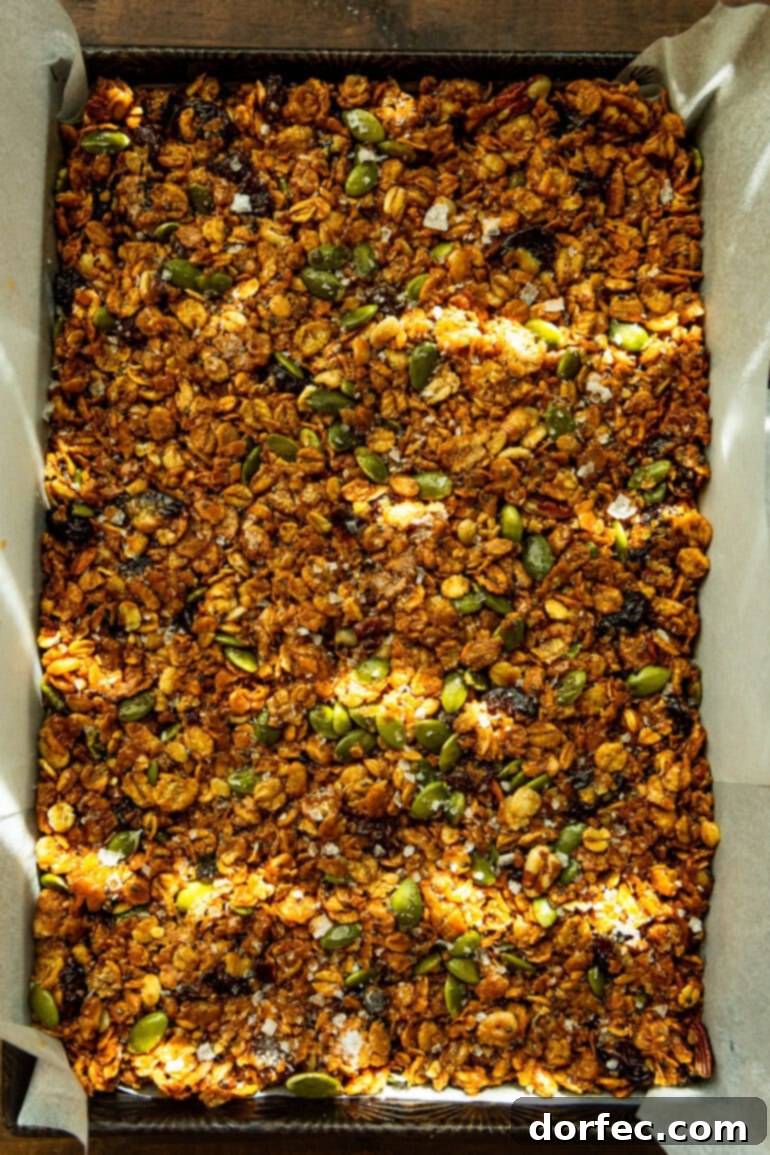 Homemade Cereal Bars 5 A batch of peanut butter cereal bars firmly pressed into a 9x13 inch pan, showcasing their compact and even texture.