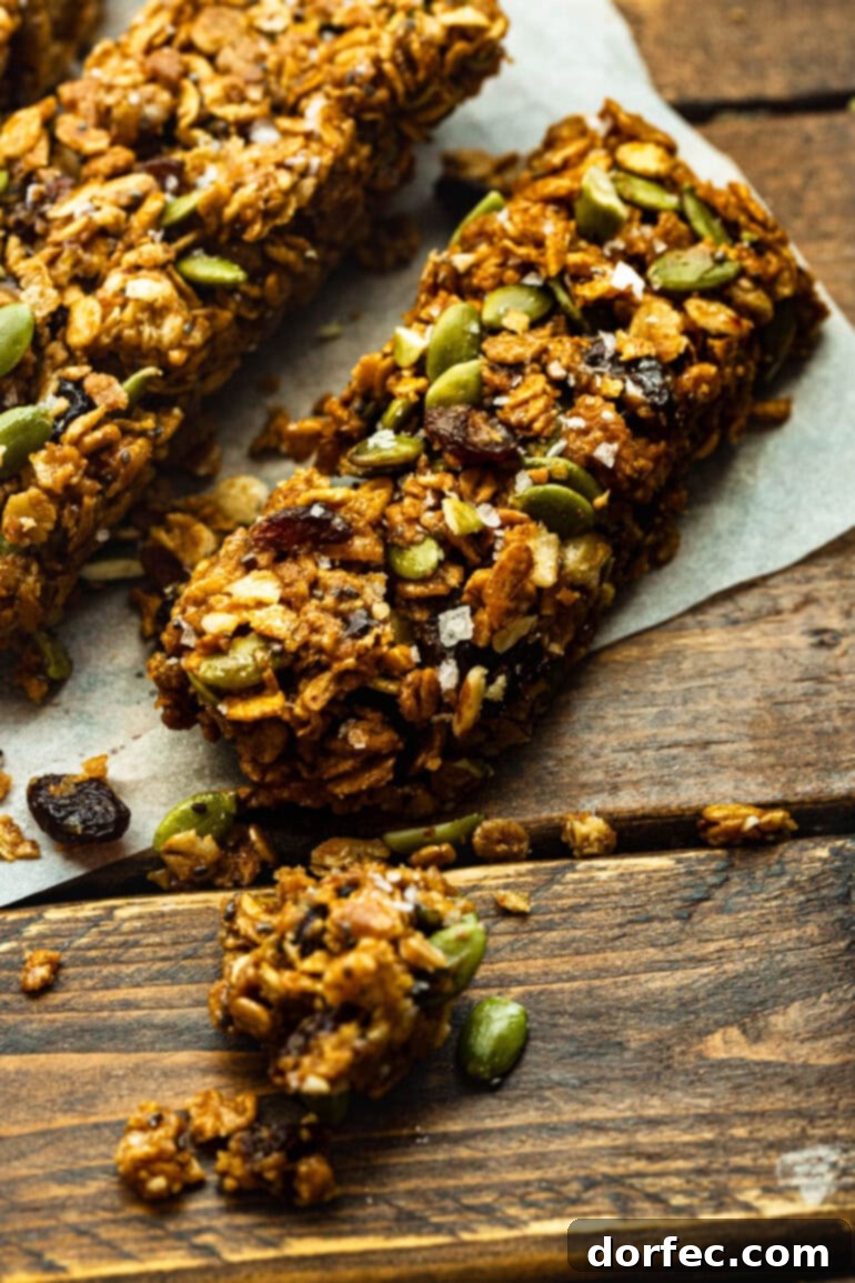 Homemade Cereal Bars 6 Several chewy oat cereal bars arranged on a rustic wooden table, emphasizing their natural and wholesome appeal.