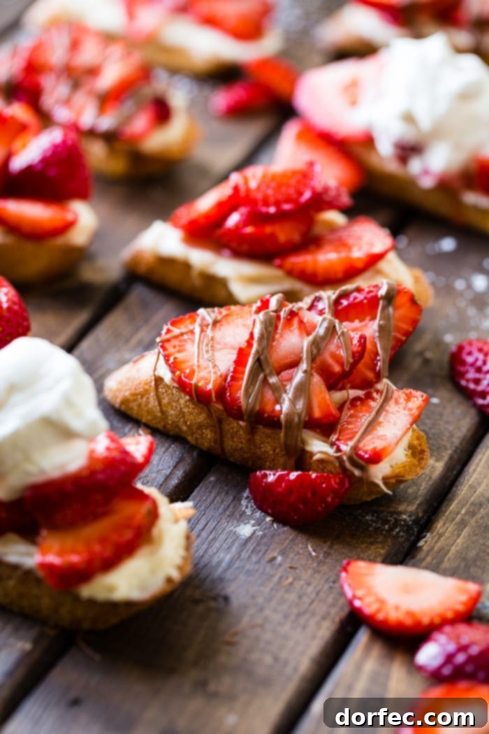 Golden Brown Sugar Strawberry Crostini 4 A brown board showcasing three Brown Sugar Strawberry Crostinis, with one piece beautifully drizzled with chocolate.