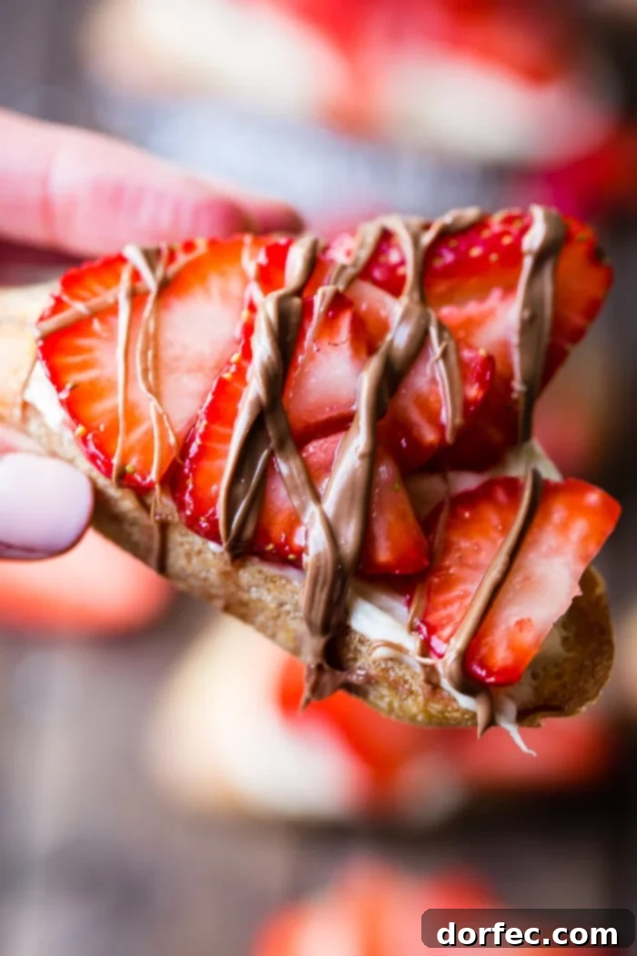 Golden Brown Sugar Strawberry Crostini 5 A brown board with Brown Sugar Strawberry Crostinis, elegantly finished with a luscious chocolate drizzle, ready for serving.