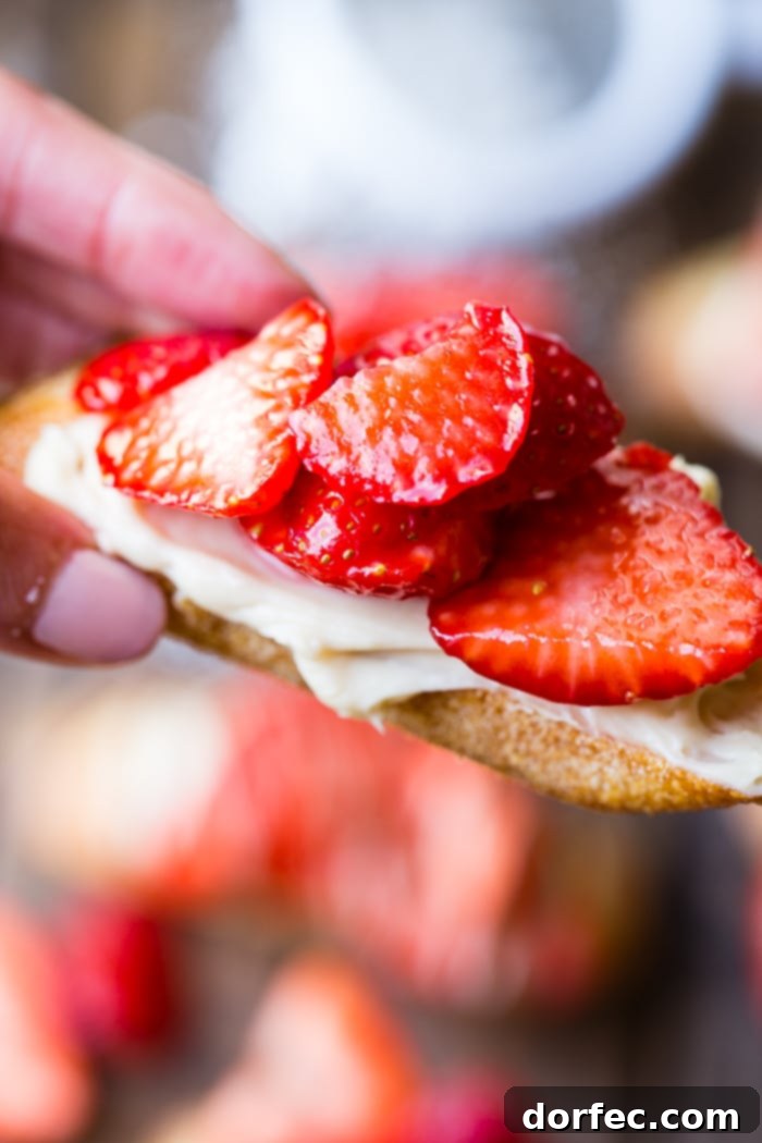 Golden Brown Sugar Strawberry Crostini 7 A minimalist shot of Brown Sugar Strawberry Crostinis arranged on a dark brown serving board, showcasing their simple elegance.