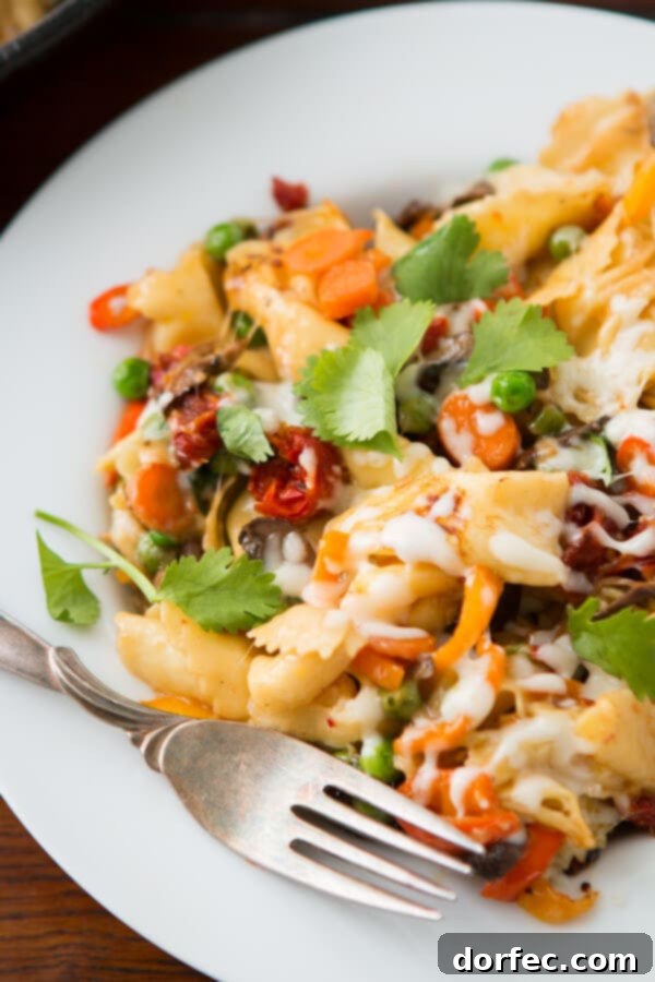 Close-up of cheesy pan fried tortellini in a cast iron skillet with golden brown edges
