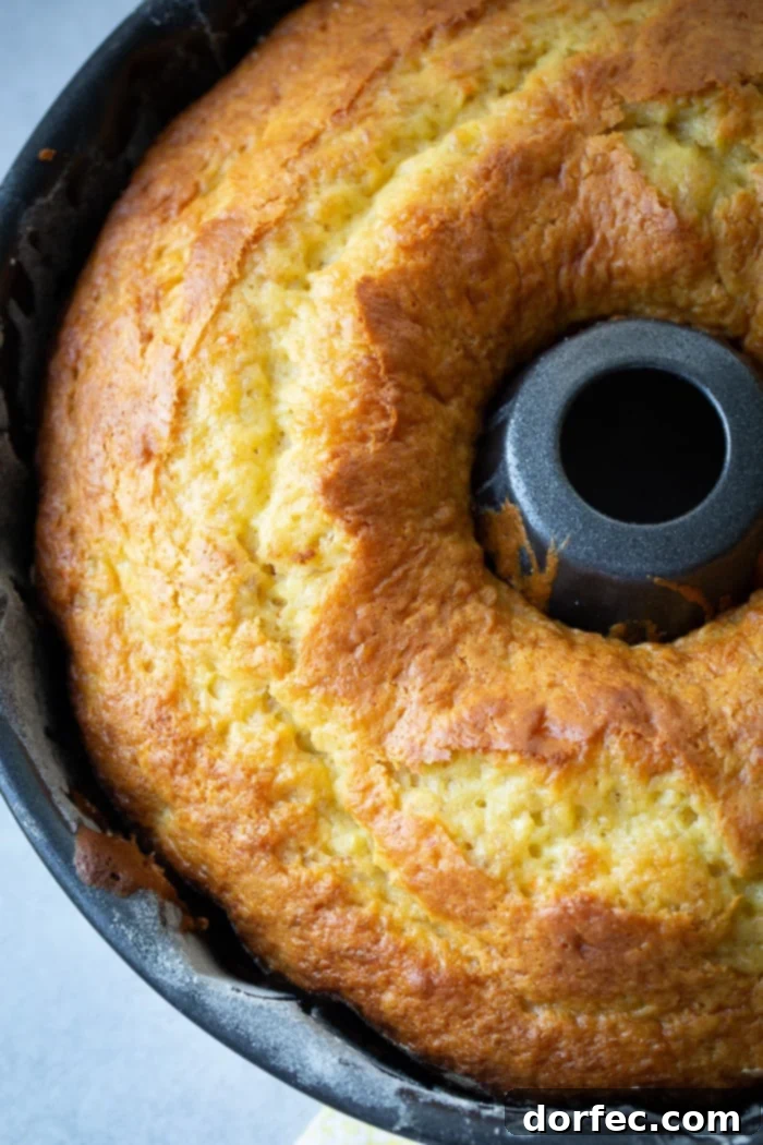 Heavenly Banana Bundt Cake 2 A dark bundt pan with a beautiful, bright yellow banana pudding bundt cake
