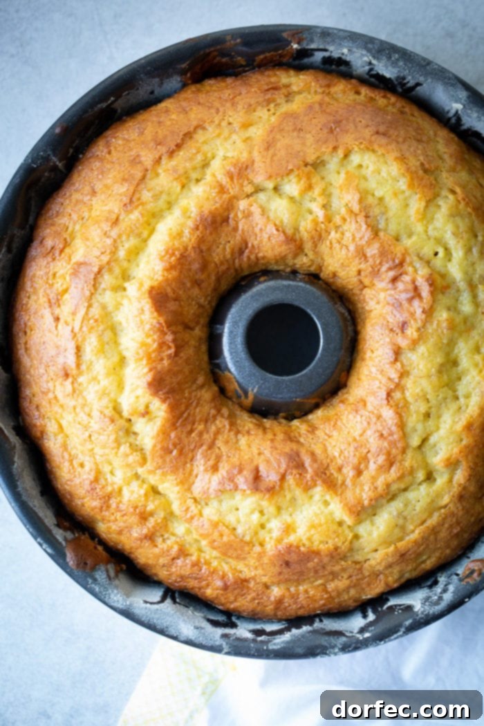 Heavenly Banana Bundt Cake 5 A dark bundt pan with a beautiful, bright yellow banana pudding bundt cake