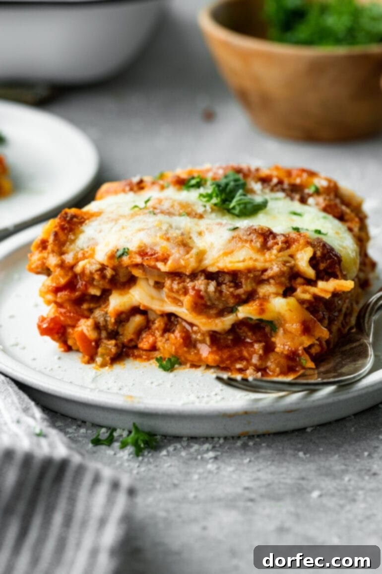 a photo of a baked meaty lasagna with the corner cut into