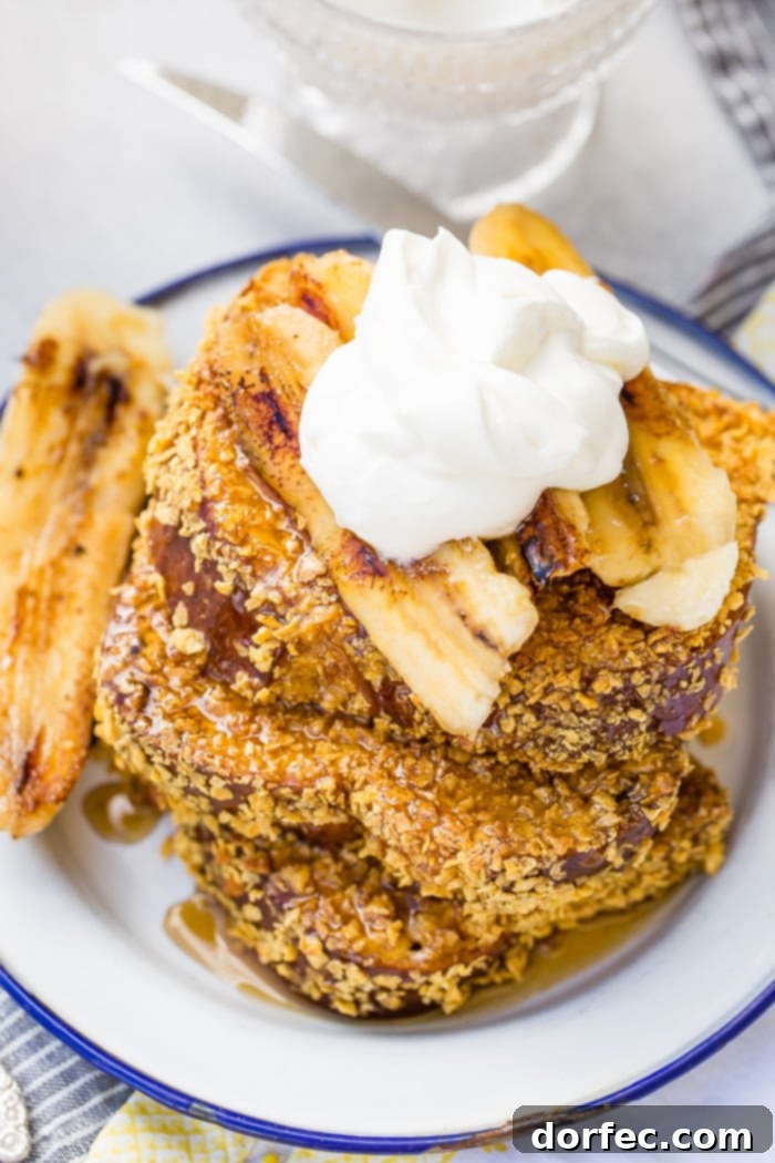 Cades Signature Bananas Foster French Toast 3 A vibrant close-up of Bananas Foster French Toast, highlighting the golden-brown crust and glistening banana syrup, ready to be enjoyed.