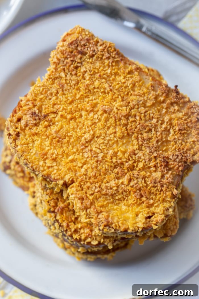 Cades Signature Bananas Foster French Toast 4 A close-up view of French toast slices, each meticulously coated in a crunchy cornflake crust, promising a satisfying texture with every bite.