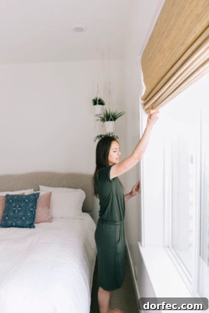 Clean white bedding paired with natural weave cordless blinds, showcasing a serene and functional guest bedroom design.
