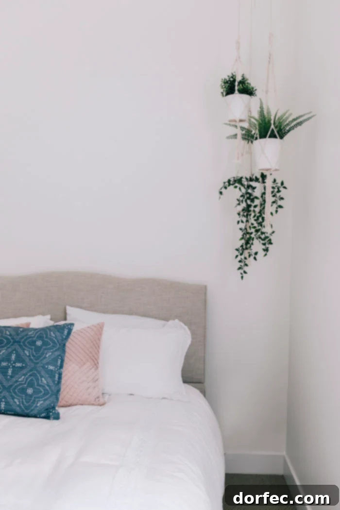 A beautifully decorated guest bedroom, offering a glimpse into the finished basement renovation, emphasizing comfort and style.