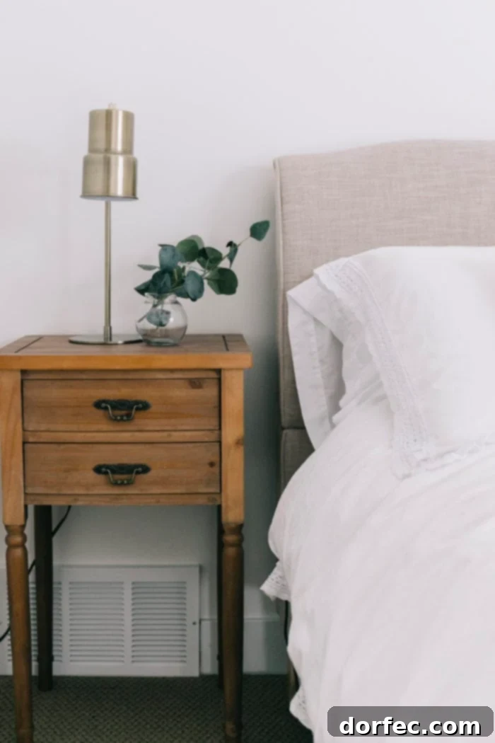 Stylish details of a guest bedroom from a basement remodel, including bedding and decorative accents.