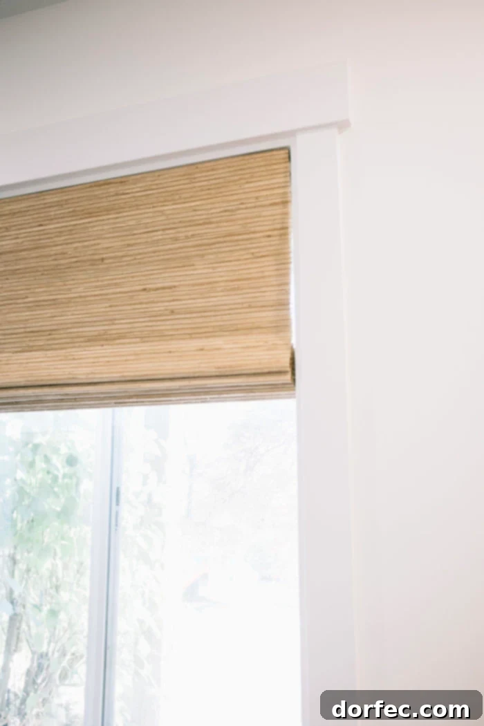 Elegant natural weave cordless blinds installed on windows, offering a safe and sophisticated window treatment solution for any modern home.