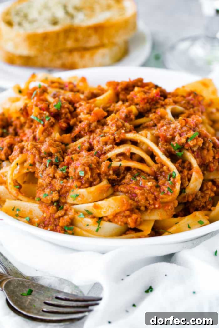 A white pasta dish full of fettuccini loaded with authentic Italian Bolognese sauce 