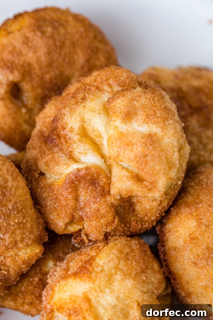 A perfectly golden-baked Apple Empty Tomb Roll, showing the delicate flakiness of the crust and a hint of the caramel inside.