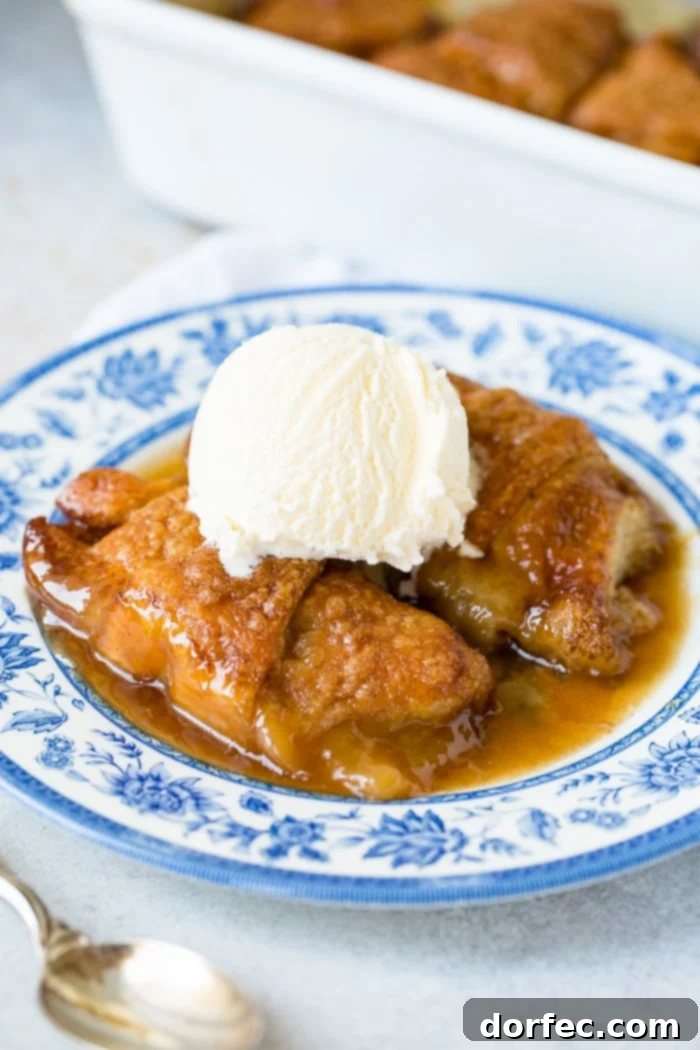 Sweet Simple Sprite Apple Dumplings 8 A family favorite: two apple dumplings with caramel sauce and vanilla ice cream, served on a beautiful blue china plate.