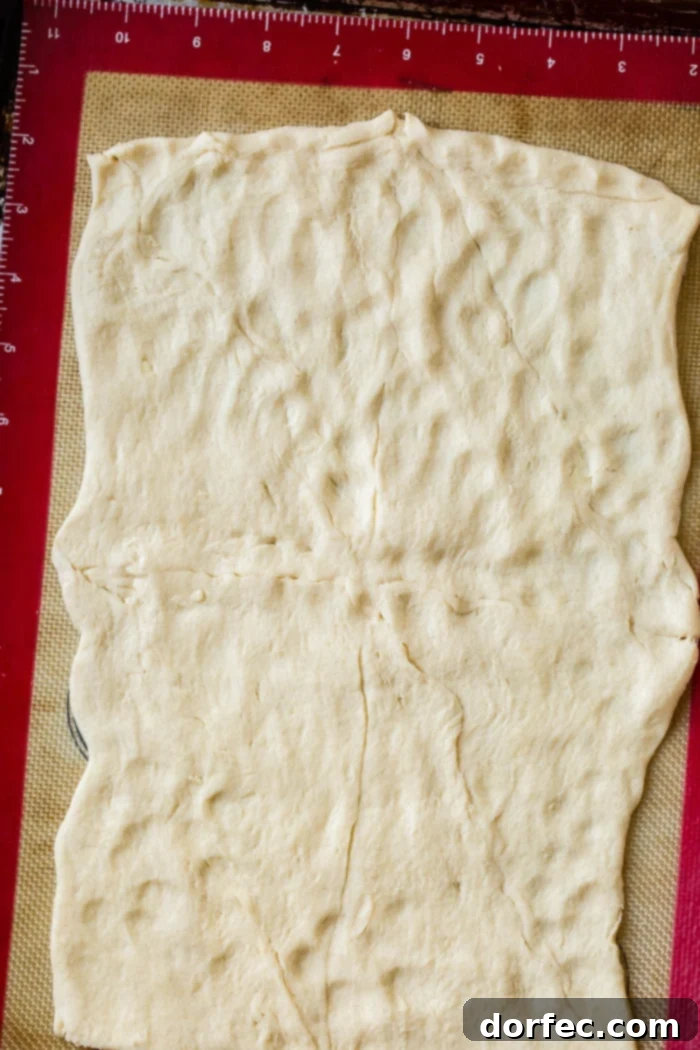 a roll of crescent roll dough with seams pinched together