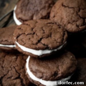 a photo of several homemade oreo cookies piled on each other sitting on a circular wire cooling rack