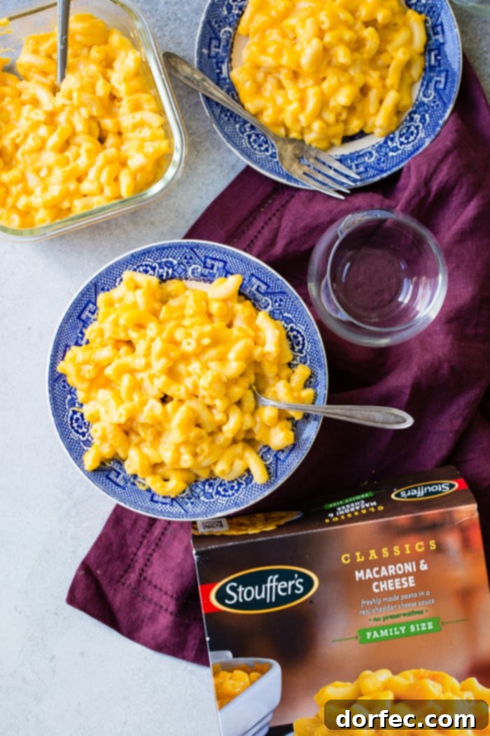 Stouffer's macaroni & cheese, a comforting meal, served with a side of colorful roasted vegetables