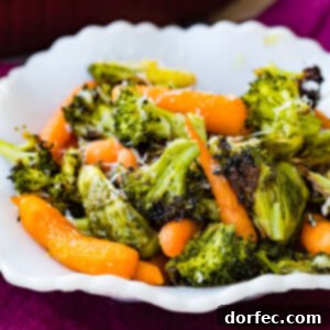 A white bowl filled with simple roasted garlic vegetables including carrots, brussels sprouts, and broccoli, topped with parmesan cheese, presented as a recipe image