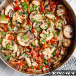 a skillet full of saucy sauteed mushrooms