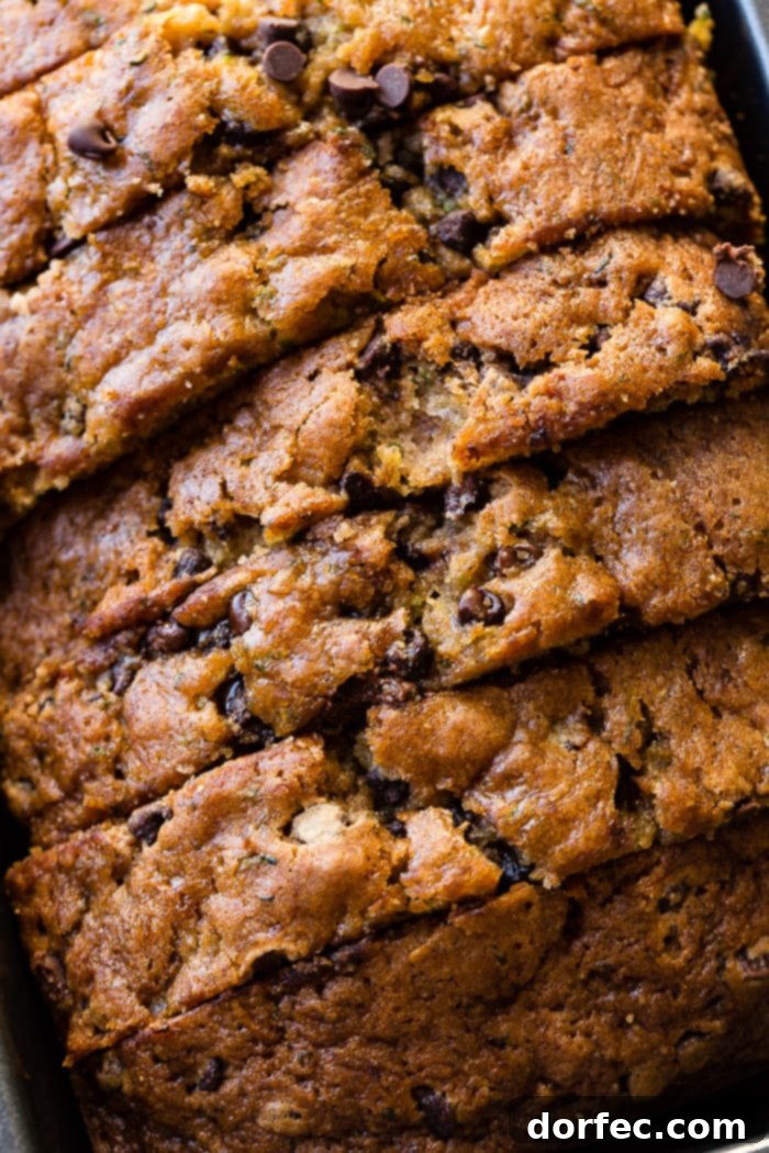 Decadent Chocolate Chip Zucchini Loaf 6 an overhead picture of a loaf of sliced chocolate chip zucchini bread still in the bread pan