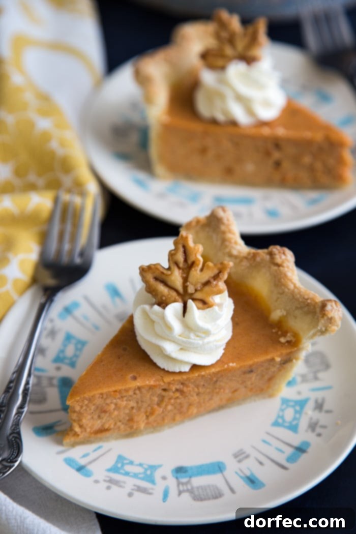 Generous slices of sweet potato pie with cheesecake filling, perfectly presented on individual plates, ready to be savored.
