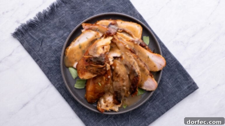 An overhead view of a beautifully smoked turkey, expertly sliced and ready to be served, showcasing its tender texture.