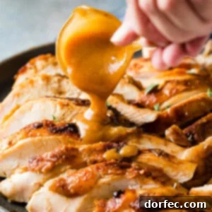 A perfectly smoked apple pecan turkey breast on a platter.