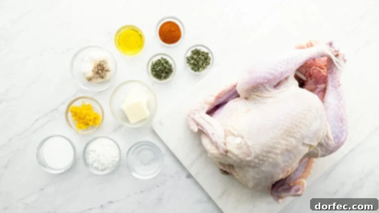 A raw whole turkey on a cutting board, surrounded by small bowls of fresh herbs, butter, garlic, and lemon zest for the herb butter rub.